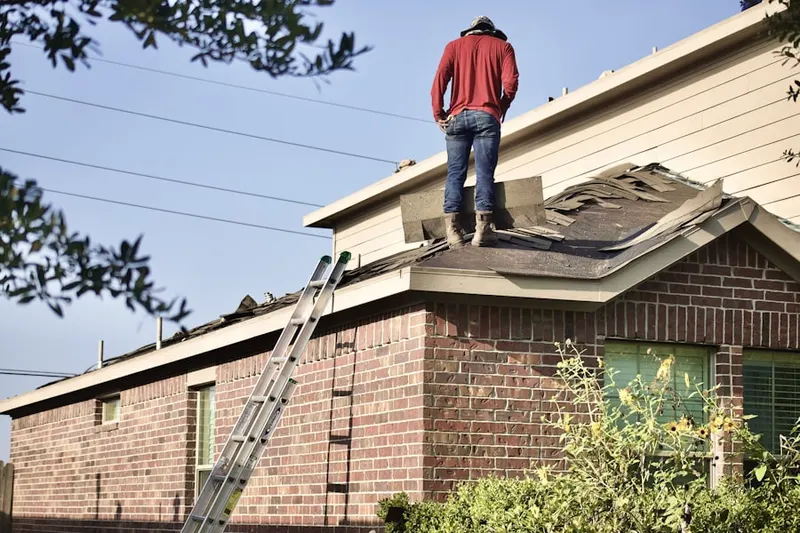 Professional roofer working on a residential roof in Fairlawn Manor